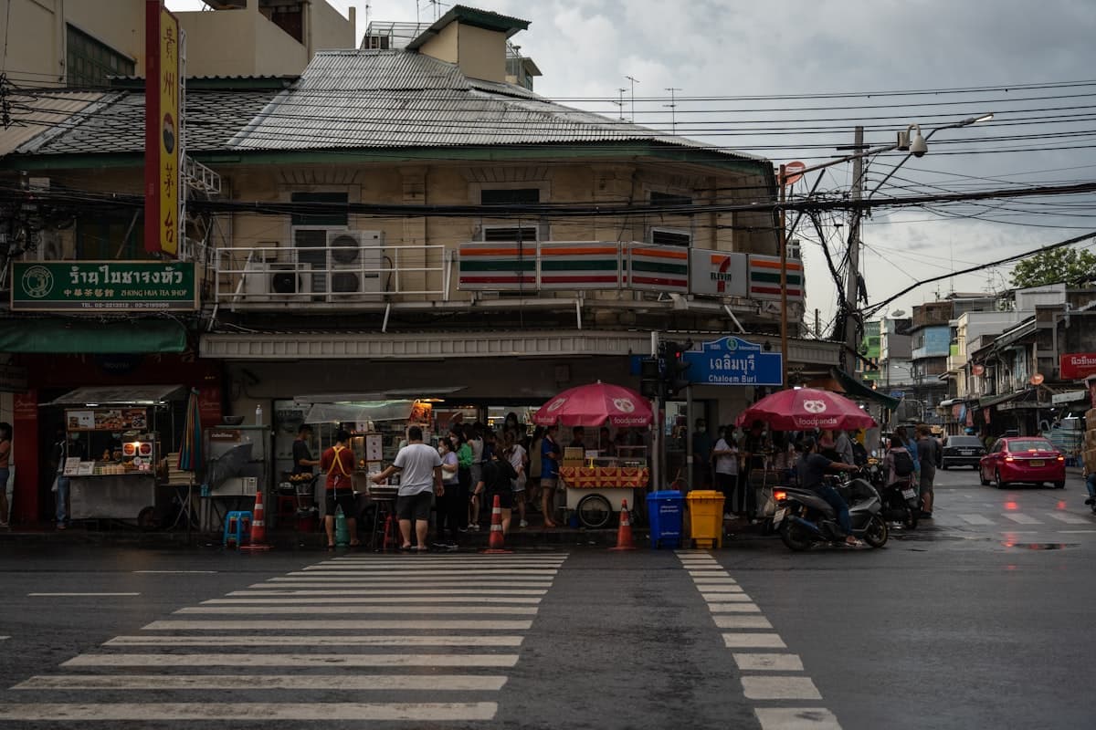 Bangkok street corner with Thai street sign เฉลิมบุรี and tea shop ร้านใบชาจงหัว